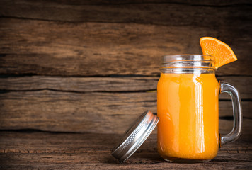 Glass of Orange Juice with Slice Fruit on Vintage Wood Table with Copy Space Background
