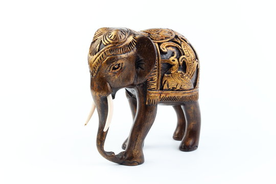 gold and brown elephant made of resin like wood carving with candle holder with white sesame. Stand on white background, Isolated, Art Model Thai Crafts, For decoration Like in the spa.