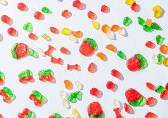 elevated view of tasty scattered jelly candies on white