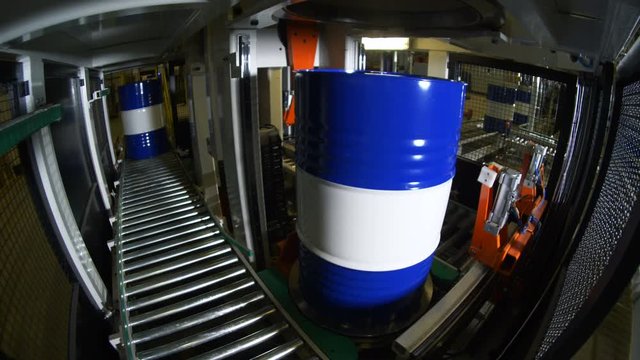 close view liquid barrels move along plant production line