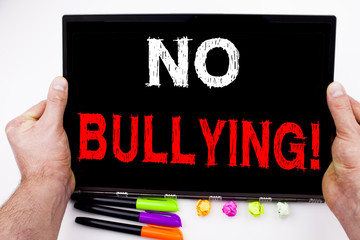 No Bullying written on tablet, computer in the office with marker, pen, stationery. Business concept for Bullies Prevention Against School Work or Cyber Internet Harassment white background space