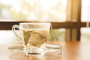 hot tea in glass. a cup of Chinese tea and light in cafe.