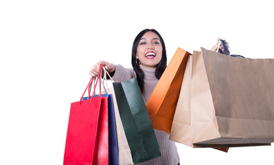 Shopping woman holding shopping bags on white background . Beautiful young  asian shopper smiling...