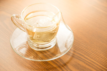 hot tea in glass. a cup of Chinese tea and light in cafe.