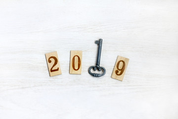 key of access/ metal key and wooden numbers denoting the year