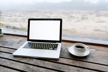 Mockup image of laptop with blank white screen on wooden table in terrace nearby river.