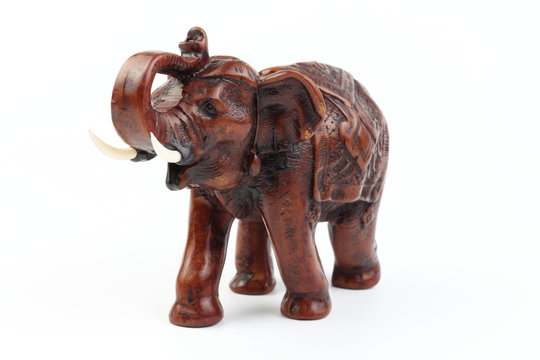 Brown elephant made of resin like wood carving with candle holder with white ivory. Stand on white background, Isolated, Art Model Thai Crafts, For decoration Like in the spa.