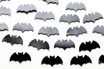Black bat shapes on a white background. Halloween background