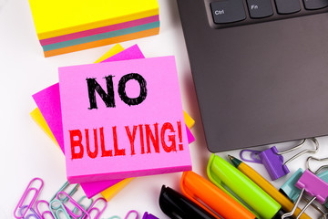 Writing text showing No Bullying made in the office with surroundings such as laptop, marker, pen....