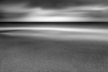 Wave over sand on Cornish beach