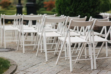 Fototapeta na wymiar White chair on wedding ceremony. summer wedding decoration outside