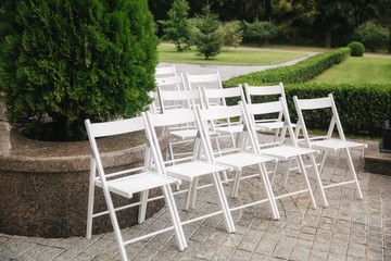 White chair on wedding ceremony. summer wedding decoration outside