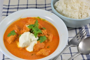Curry with rice in bowls on a checkered cloth