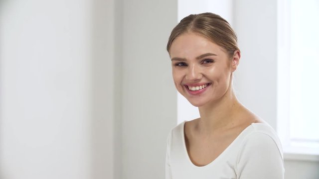 Portrait Of Happy Woman With Natural Beauty In White Interior