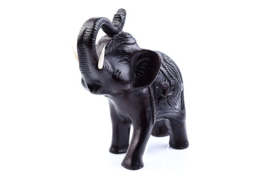 Black elephant made of resin like wooden carving with white ivory. Stand on white background, Isolated, Art Model Thai Crafts, For decoration Like in the spa.