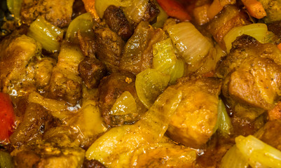 Roast meat, onions, carrots and spices, boiling in oil