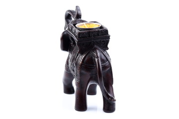 elephant made of resin like wooden carving with candle holder with white ivory. Stand on white background, Isolated, Art Model Thai Crafts, For decoration Like in the spa.