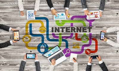 Top view of businesspeople sitting at table and using gadgets