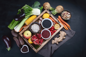 Fresh vegetables and legumes in wooden box.