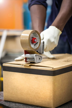 Box Being Taped Shut In Packaging Plant.