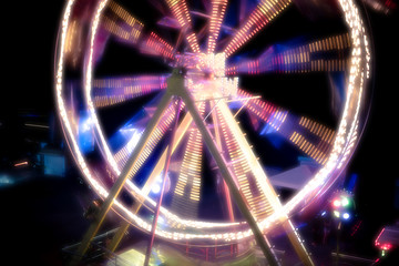 Ferris wheel in a night park. Entertainment in the carnival park.