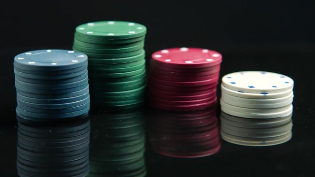 Poker chips on the black mirror surface