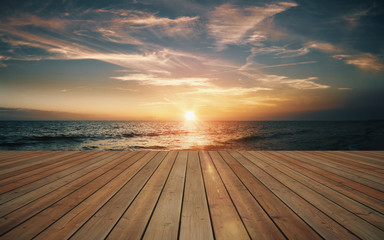 Naklejka na ściany i meble Empty wooden deck and beautiful sunset on the sea