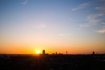 Fototapeta na wymiar Sunset over liverpool with liverpool cathedral and radio city tower silhouettes