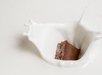 Chocolate falls in milk