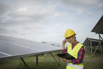 Engineer electric woman checking and maintenance of solar cells.