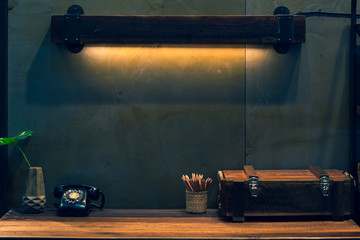 Wooden vintage desk and wall lamp with antique telephone retro style