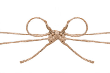 Natural brown jute twine hemp rope, tie a knot / bow in the middle of the cord. Isolated on white background. 
