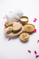 Fototapeta na wymiar Herbal or Ayurvedic face Pack using Multani mitti, milk etc placed with Soap, towel. Selective focus