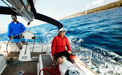 Attractive strong woman sailing with her boat