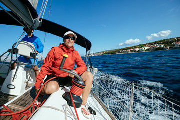 Attractive strong woman sailing with her boat