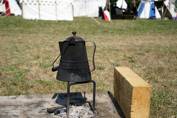 Primitive cooking on open flame with old pots and pans in Germany on a feast 
