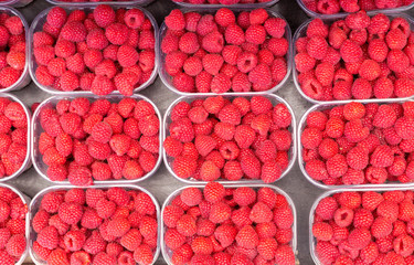 Ripe Raspberries Background. Juicy Raspberries On The Market Place.