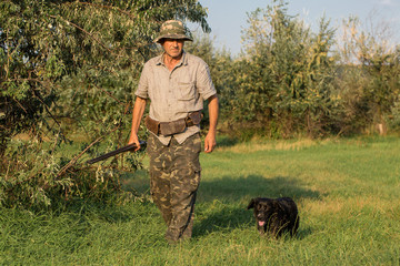 Hunter with a German trotter and spaniel, hunting a pheasant with dogs	
