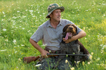Hunter with a German trotter and spaniel, hunting a pheasant with dogs