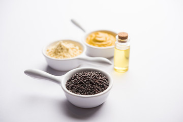 Rai or raw Mustard with sauce, powder and oil, over moody background. Selective focus
