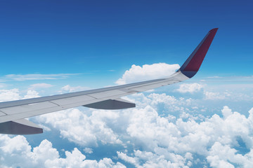 Wing of an airplane flying above the clouds.beautiful blue sky with cloud.Blue sky with clouds for...