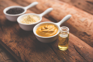 Rai or raw Mustard with sauce, powder and oil, over moody background. Selective focus
