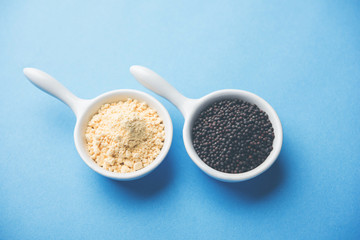 Rai or raw Mustard with sauce, powder and oil, over moody background. Selective focus
