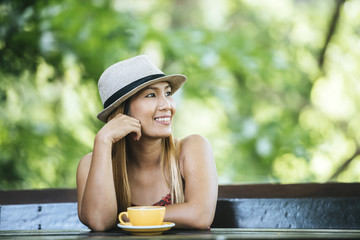 Happy young woman with latte coffee in morning
