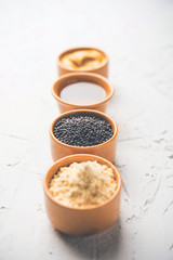 Rai or raw Mustard with sauce, powder and oil, over moody background. Selective focus
