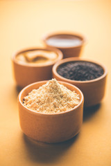 Rai or raw Mustard with sauce, powder and oil, over moody background. Selective focus
