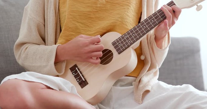 Woman playing song with ukulele