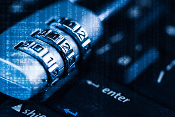 The abstract image of the padlock located on the top of enter button on computer keyboard overlay with binary code image. the concept of data, hardware, information technology and cyber security.