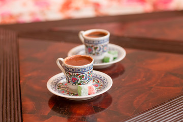Two traditional porcelain turkish coffee cups with turkish delight