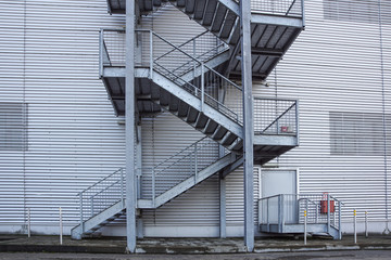 Abstract industrial architecture fragment on blue sky background, metal stairway sections